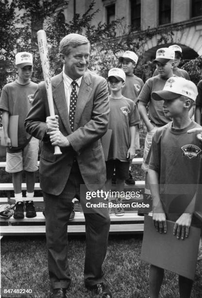 Govenor William Weld accepts a baseball bat while honoring a Little League baseball team from Middleboro, Mass., on Sept 1, 1994.