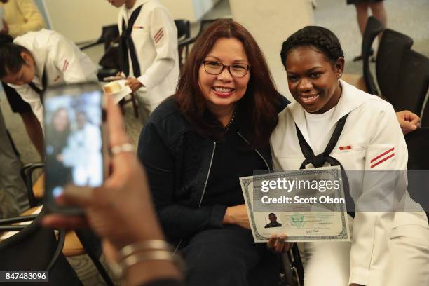 Shari Mahon, from Jamaica and currently serving in the U.S. Navy at Naval Station Great Lakes, poses for a picture with U.S. Senator Tammy Duckworth...