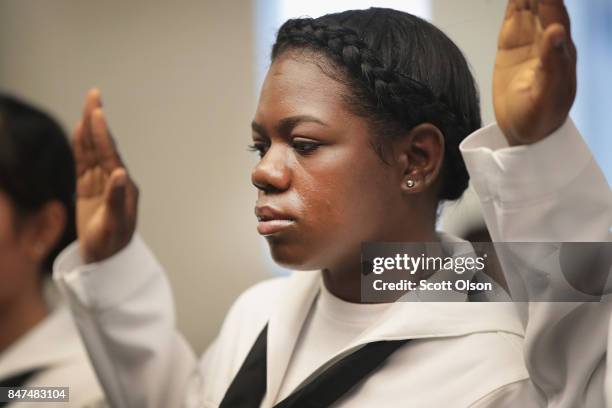 Shari Mahon, who was born in Jamaica and is currently serving in the U.S. Navy, takes the Oath of Allegiance to become a U.S. Citizen alongside other...