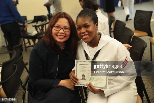 Adiaraton Sidibe, from Mali and currently serving in the U.S. Navy at Naval Station Great Lakes, poses for a picture with U.S. Senator Tammy...