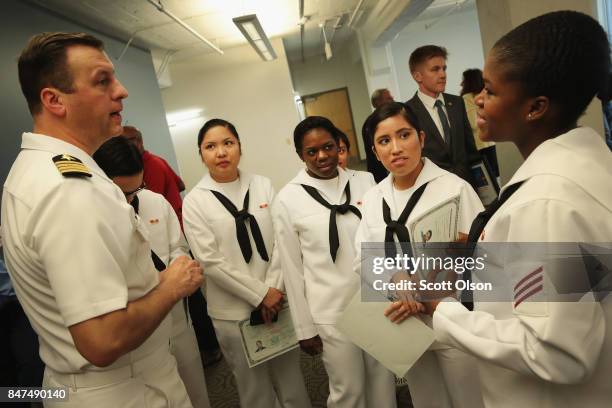 Captain James Hawkins , Commanding Officer of Naval Station Great Lakes, speaks with sailors under his command after they were sworn in as U.S....