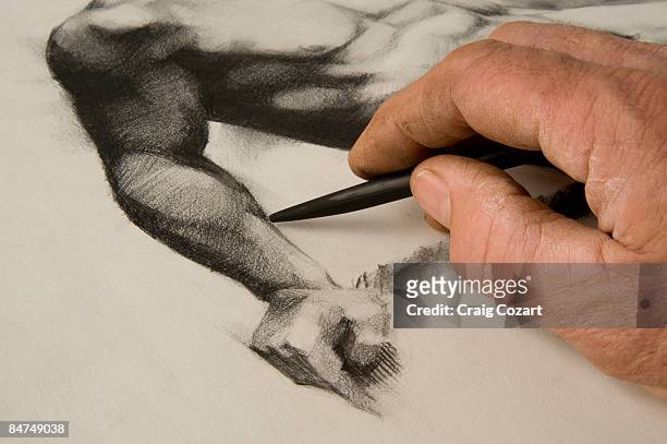 artist's hand and sketch. - drawing charcoal stockfoto's en -beelden