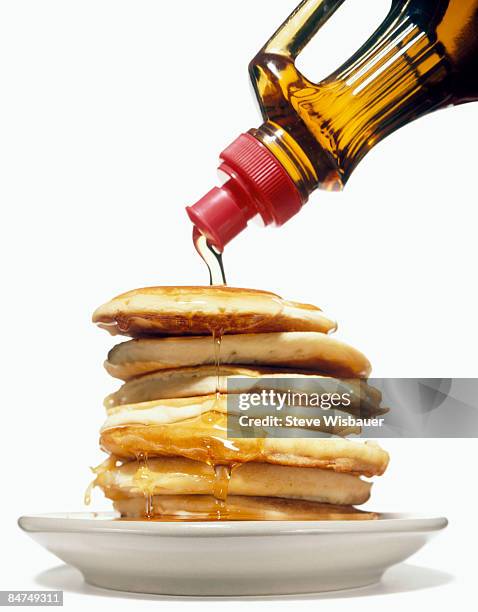 stack of pancakes on a plate with syrup pouring  - pancake fotografías e imágenes de stock