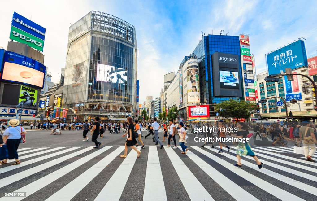 Pedestrians are running through the street at Shibuya crossing