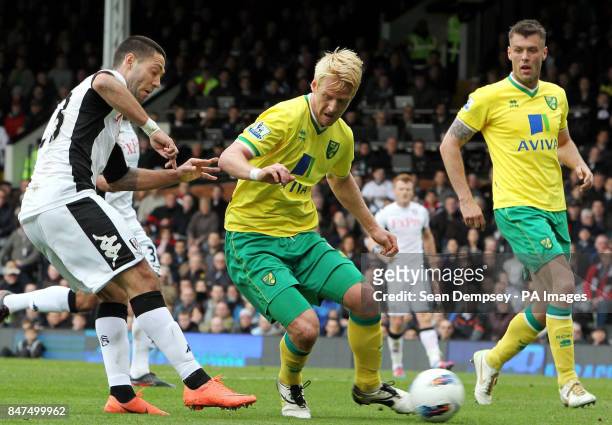 Fulham's Clint Dempsey and Norwich City's Zak Whitbread battle for the ball during the Barclays Premier League match at Craven Cottage, London.