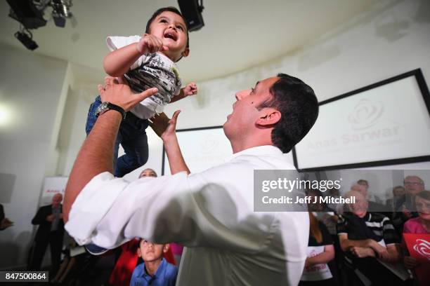 Anas Sarwar is seen on stage with his family at the launch of his campaign to be Scottish Labour leader at the Gorbals Parish Church on September 15,...