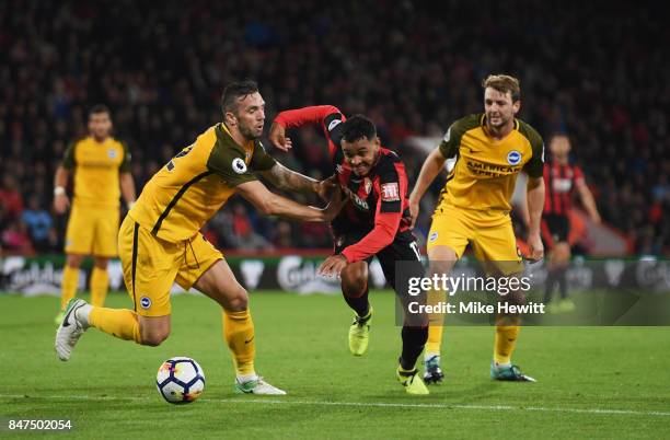 Joshua King of AFC Bournemouth takes on Shane Duffy and Dale Stephens of Brighton and Hove Albion during the Premier League match between AFC...