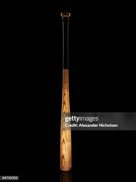 baseball-bat on black background - baseballschläger stock-fotos und bilder