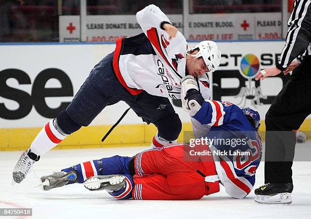 Aaron Voros of the New York Rangers is thrown to the ice in a fight against Matt Bradley of the Washington Capitals on February 11, 2009 at Madison...