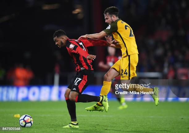 Joshua King of AFC Bournemouth fends off Davy Propper of Brighton and Hove Albion during the Premier League match between AFC Bournemouth and...