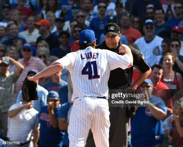 John Lackey of the Chicago Cubs argues a call with home plate umpire Jordan Baker during the fifth inning of a game against the St. Louis Cardinals...