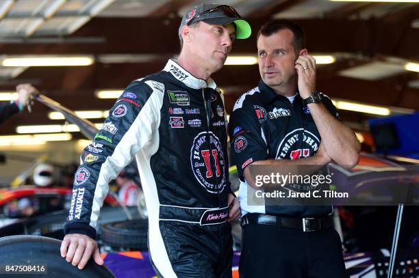 Kevin Harvick, driver of the Jimmy John's Ford, speaks with his crew chief Rodney Childers in the garage area during practice for the Monster Energy...