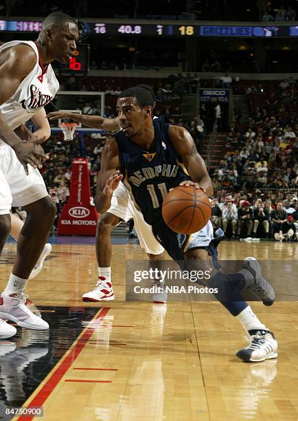 Mike Conley of the Memphis Grizzlies drives against Theo Ratliff of the Philadelphia 76ers on February 11, 2009 at the Wachovia Center Philadelphia,...