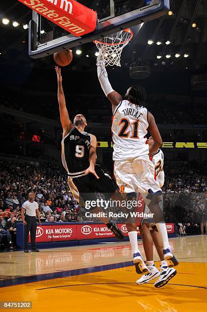 Tony Parker of the San Antonio Spurs shoots a layup against Ronny Turiaf of the Golden State Warriors during the game at Oracle Arena on February 2,...