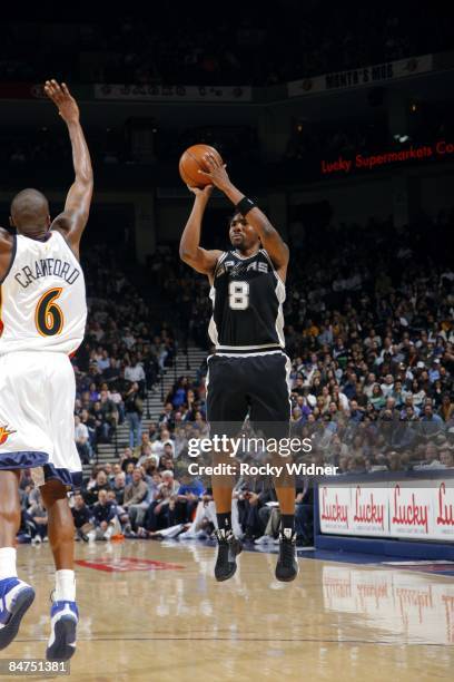 Roger Mason of the San Antonio Spurs shoots a jump shot over Jamal Crawford of the Golden State Warriors during the game at Oracle Arena on February...