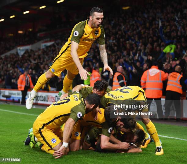 Shane Duffy of Brighton and Hove Albion joins team mates as they congratulate Solly March of Brighton and Hove Albion as he scores their first goal...
