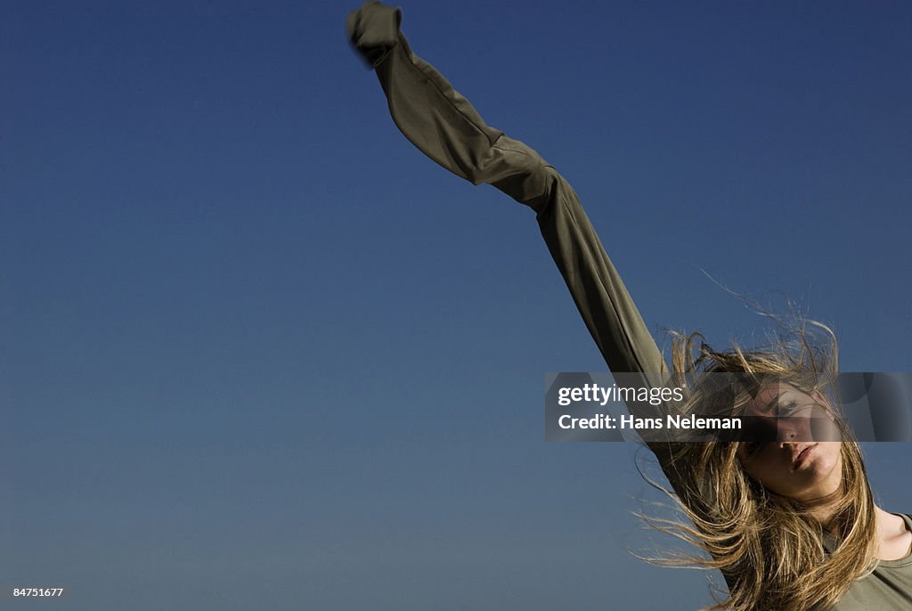 Young woman with her sleeve in the air
