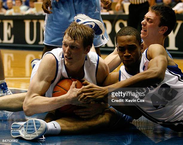 Tyler Hansbrough of the North Carolina Tar Heels battles for a loose ball with Kyle Singler and Lance Thomas of the Duke Blue Devils during the game...