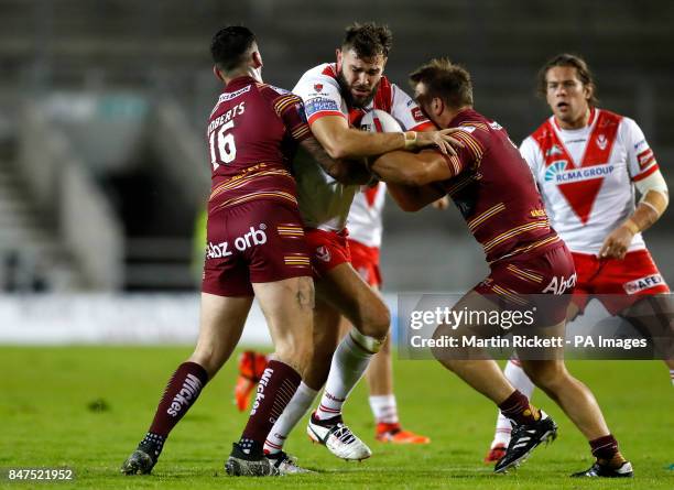 St Helens Alex Walmsley is tackled by Huddersfield Giants Oliver Roberts and Paul Clough , during the Betfred Super8's match at The Totally Wicked...