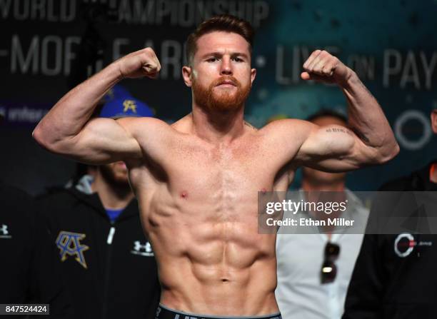 Boxer Canelo Alvarez poses on the scale during his official weigh-in at MGM Grand Garden Arena on September 15, 2017 in Las Vegas, Nevada. Alvarez...