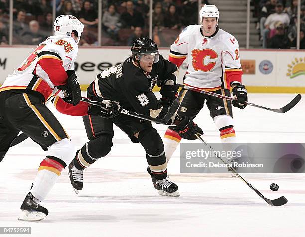 Adam Pardy and Curtis Giencross of the Galgary Flames try to defend Teemu Selanne of the Anaheim Ducks during the game on February 11, 2009 at Honda...