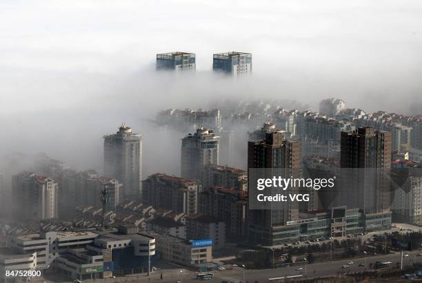 Buildings are engulfed in fog on February 11, 2009 in Yantai, China. The advection fog was caused by a warm front which passed over the city for more...