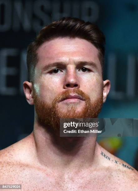 Boxer Canelo Alvarez poses on the scale during his official weigh-in at MGM Grand Garden Arena on September 15, 2017 in Las Vegas, Nevada. Alvarez...