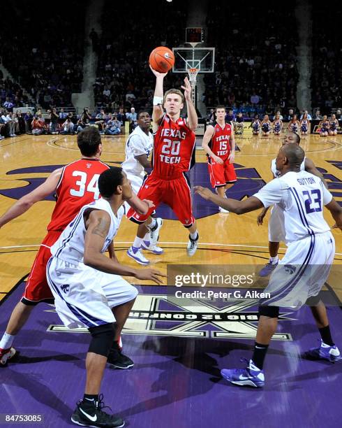 Alan Voskuil of the Texas Tech Red Raiders puts up a shot over pressure from defenders Dominique Sutton and Ron Anderson of the Kansas State Wildcats...