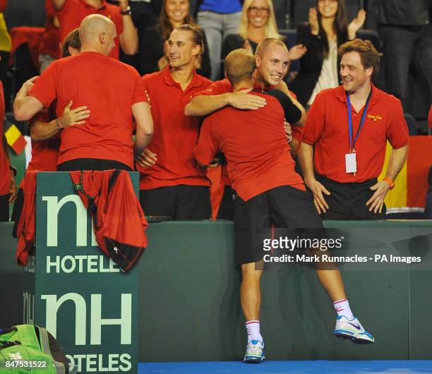 Belgium's Olivier Rochus celebrates victory over Great Britain's Dan Evans, with his team mates during day one of the Davis Cup match at the Braehead...