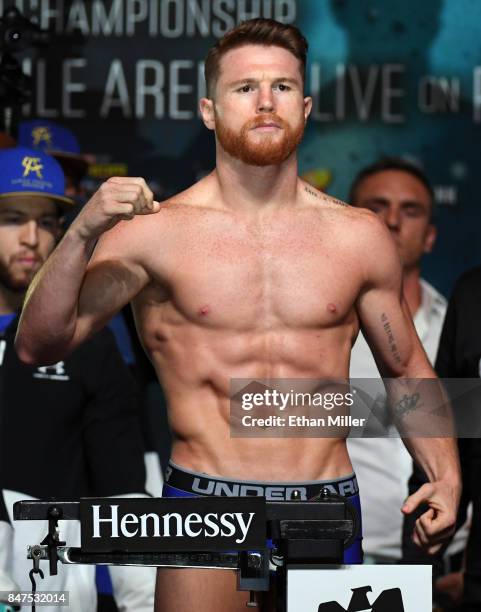 Boxer Canelo Alvarez poses on the scale during his official weigh-in at MGM Grand Garden Arena on September 15, 2017 in Las Vegas, Nevada. Alvarez...