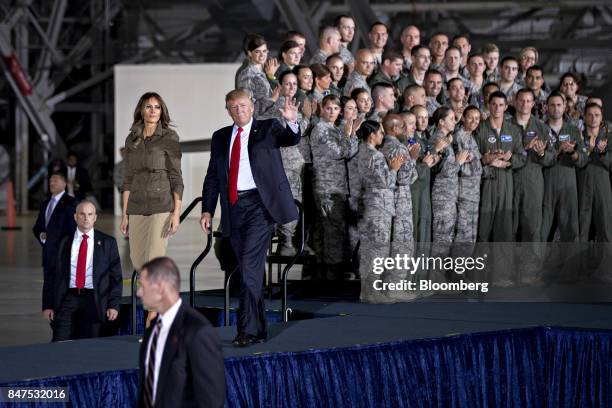 President Donald Trump waves while walking out with U.S. First Lady Melania Trump after delivering remarks to military personnel and families in an...