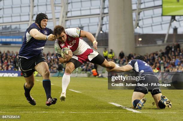 Cardiff Blues' Dafydd Hewitt gets tackled by Leinster's Mike Ross and Richie Rees