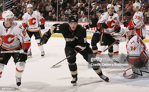 Curtis Giencross and Miikka Kiprusoff of the Calgary Flames watch Bobby Ryan of the Anaheim Ducks move to the puck during the game on February 11,...