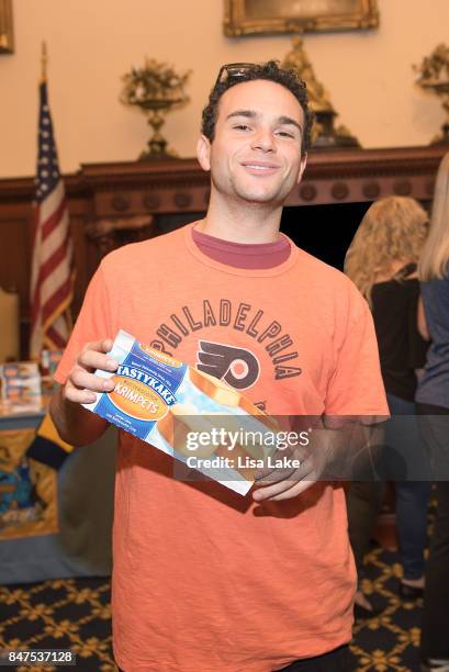 Actor Troy Gentile poses with a box of TasyKake Krimpets during an event honoring Producer Alan F. Goldberg at Philadelphia City Hall on September...