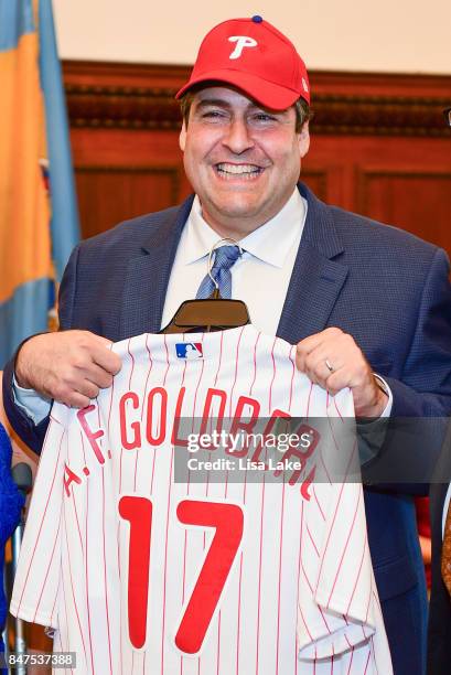 Producer Adam F. Goldberg is presented with customized official Philadelphia Phillies shirt and cap during an event honoring Goldberg at Philadelphia...