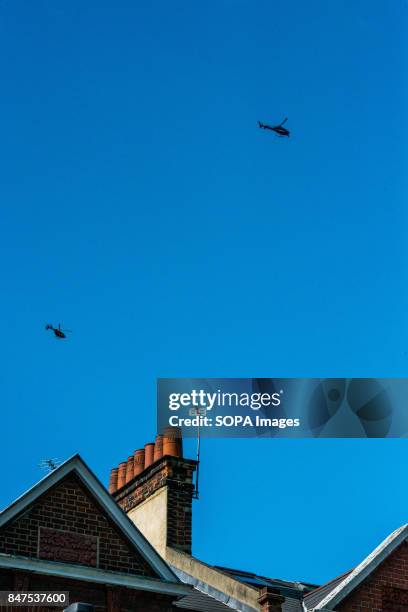 Police and news helicopters flying over Parsons Green Underground Station. Several people have been injured after an explosion on a tube train in...