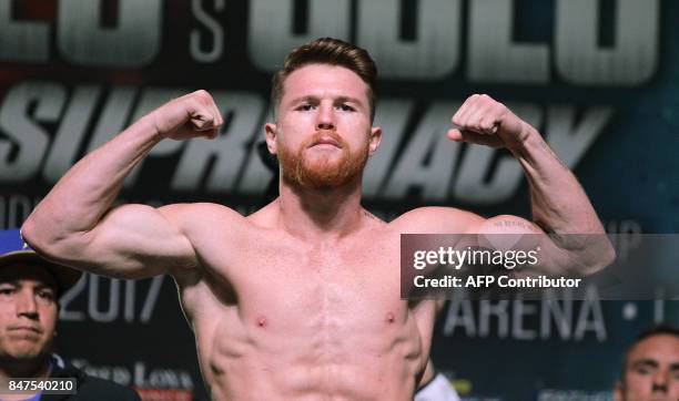 Boxer Canelo Alvarez poses on the scales during a weigh-in with Gennady Golovkin at the MGM Grand Hotel & Casino on September 15, 2017 in Las Vegas,...