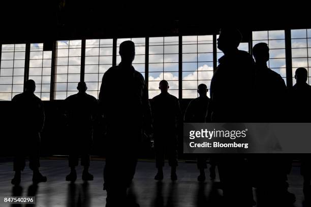 The silhouettes of members of the U.S. Air Force are seen before U.S. President Donald Trump, not pictured, speaks in an aircraft hangar at Joint...
