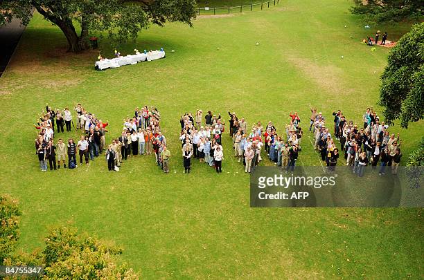 Invited guests group together to spell out the word "Darwin", in celebration of naturalist Charles Darwin, at the Sydney Royal Botanic Gardens on...