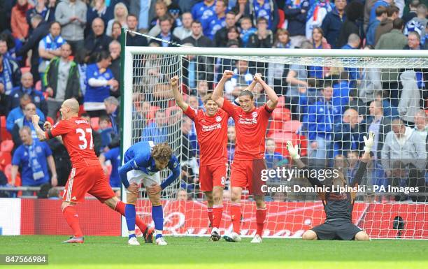 Liverpool's Andy Carroll and goalkeeper Brad Jones celebrate as Everton's Nikica Jelavic stands dejected as the final whistle is blown