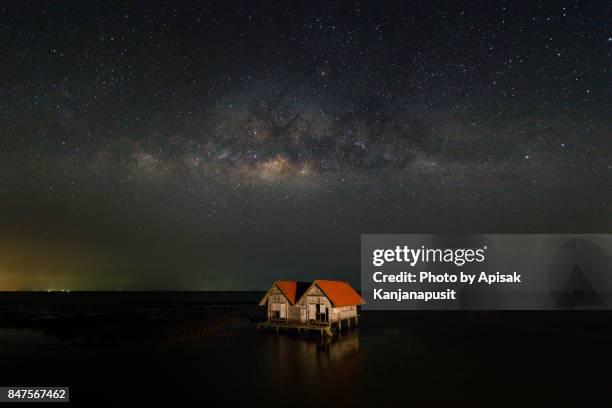 abandoned house with milky way in thale noi lake at phatthalung province, thailand. - thale noi stock pictures, royalty-free photos & images