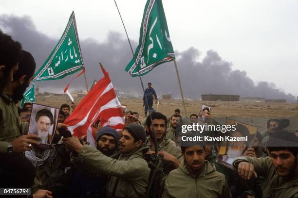 Iran's Revolutionary Guards prepare to burn an American flag on the al-Fao Peninsula after it was recaptured by Iranian forces from the Iraqi army...