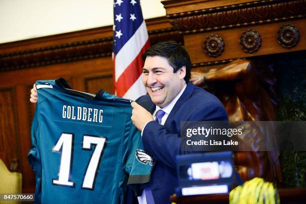Producer Adam F. Goldberg is presented with customized Philadelphia Eagles shirt during an event honoring Goldberg at Philadelphia City Hall on...