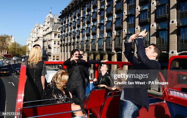 Thomas Ian Nicholas and Jason Biggs take photos while on an open top bus to promote his new film, American Pie:Reunion in London.