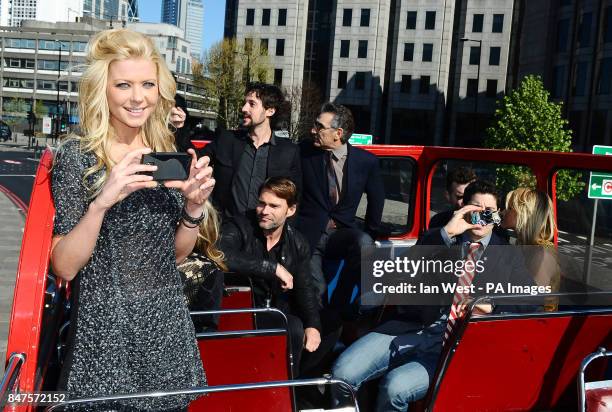 Tara Reid takes photos of the cast while on an open top bus to promote their new film, American Pie:Reunion in London.