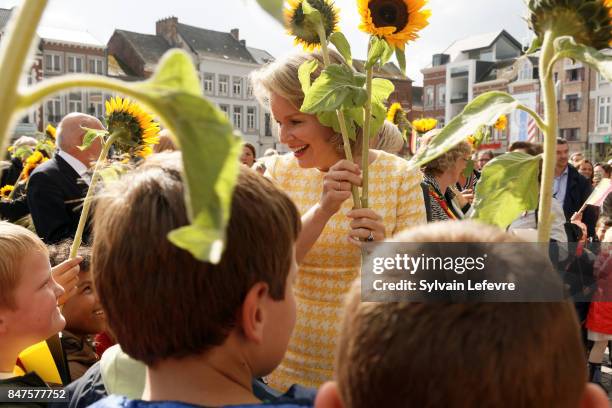 Queen Mathilde Of Belgium is welcomed by children of the city welcome with sunflowers after visiting the Eurofleurs 2017 Championship on September...