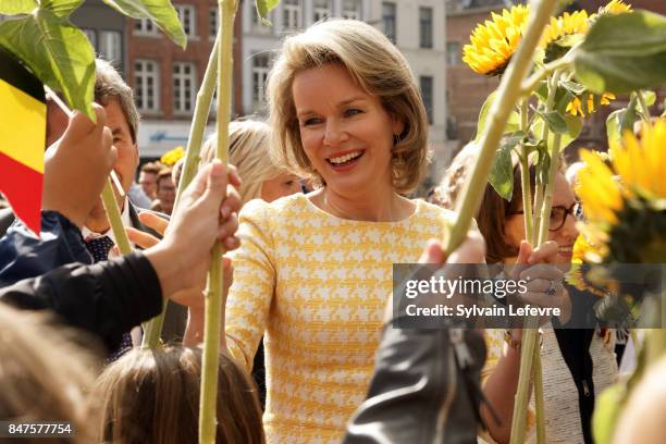 Queen Mathilde Of Belgium is welcomed by children of the city welcome with sunflowers after visiting the Eurofleurs 2017 Championship on September...