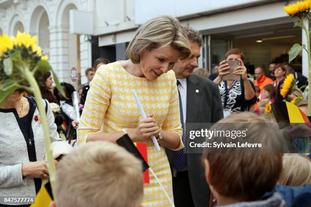 Queen Mathilde Of Belgium is welcomed by children of the city welcome with sunflowers after visiting the Eurofleurs 2017 Championship on September...