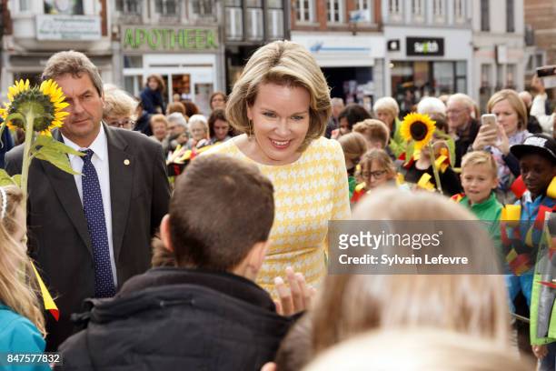 Queen Mathilde Of Belgium is welcomed by children of the city welcome with sunflowers after visiting the Eurofleurs 2017 Championship on September...