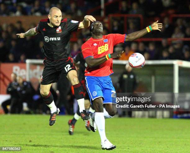 Swindon's Alan McCormack challenges Aldershot's Guy Madjo during the npower Football League Two match at the EBB Stadium, Aldershot.